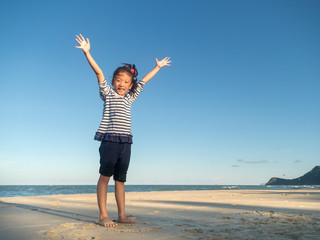 Little asian girl feeling relax on the beach