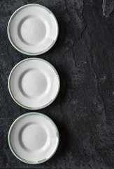 Empty plates on the black ceramic background