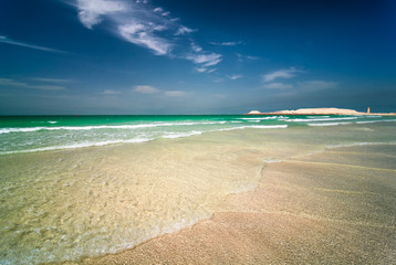 Beautiful sunny Jumeirah beach in Dubai with crystal clear sea water and amazing blue sky, Dubai, United Arab Emirates. © marekkijevsky