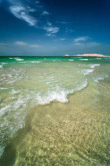 Beautiful sunny Jumeirah beach in Dubai with crystal clear sea water and amazing blue sky, Dubai, United Arab Emirates.