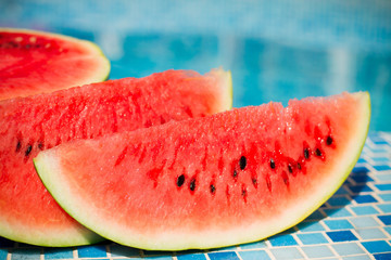 slices of fresh juicy organic watermelon on a pool