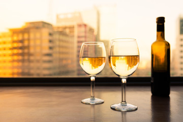 Pair of white wine glasses on a restaurant bar. 