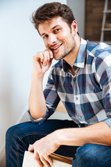 Obraz premium Close up portrait of a young handsome man sitting