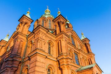 Fototapeta premium Evening scenery of Uspenski Orthodox Cathedral Church in Katajanokka district of the Old Town in Helsinki, Finland