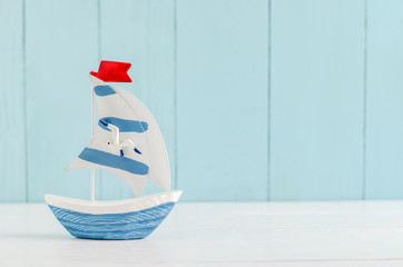 Sail boat Toy model with Seagull - Nautical background