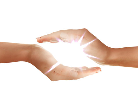 Female hands holding light on white background.