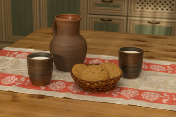 Still life with pottery, milk and cookies in the kitchen
