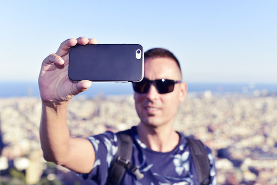 man taking a selfie in Barcelona, Spain