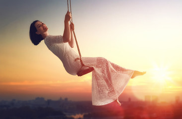young woman on a swing - obrazy, fototapety, plakaty