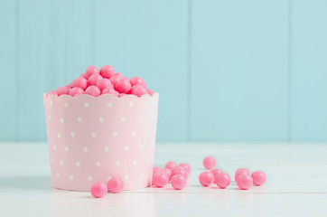 Pink candies in pink paper cup