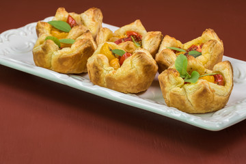Fresh baked muffin pan tomato cheese tarts.