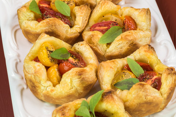 Fresh baked muffin pan tomato cheese tarts.
