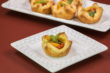 Fresh baked muffin pan tomato cheese tart.