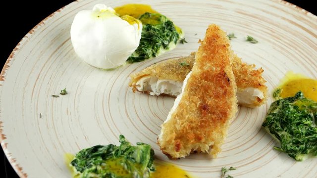 Roasted pikeperch fillet with soft poached egg and spinach
