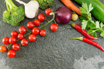 Cherry tomato and red pepper on stone background
