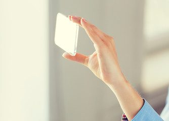 close up of woman with transparent smartphone