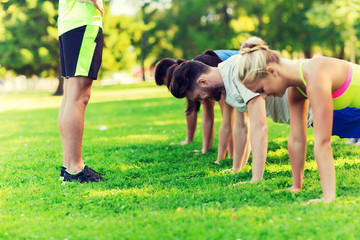 group of friends or sportsmen exercising outdoors