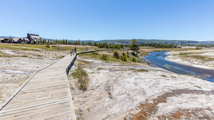 Colorful landscape of geothermal activity. Wooden walkway among gaysers near Old Faithful Geyser, Yellowstone National Park, Wyoming, USA