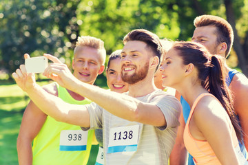 teenage sportsmen taking selfie with smartphone