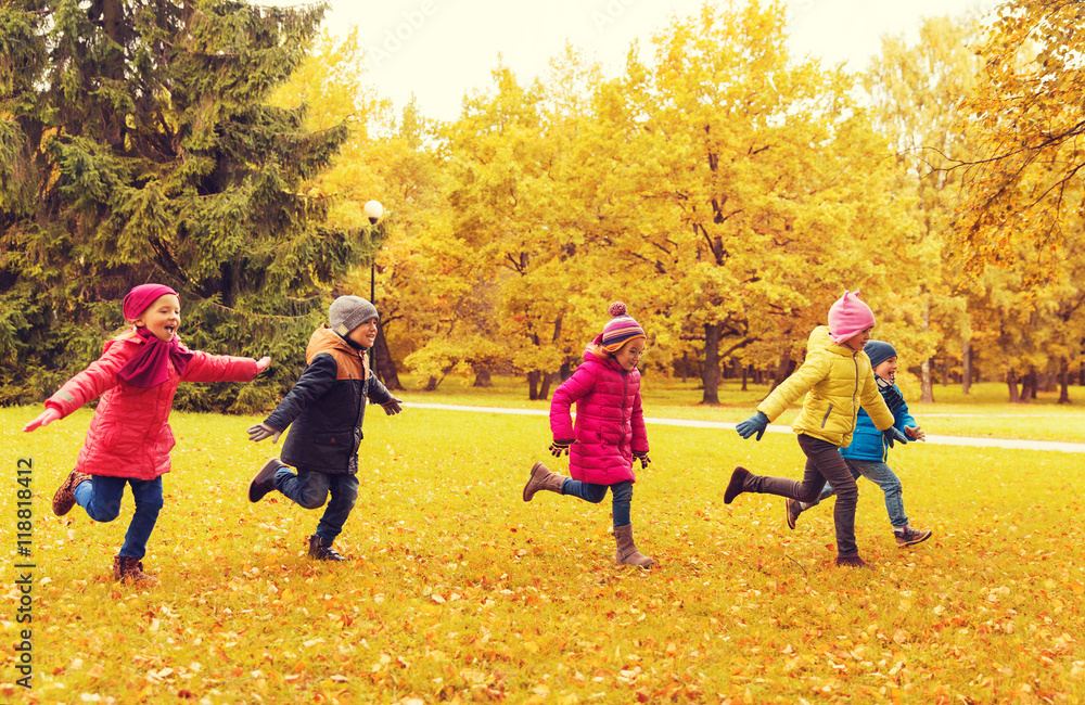 Wall mural group of happy little kids running outdoors