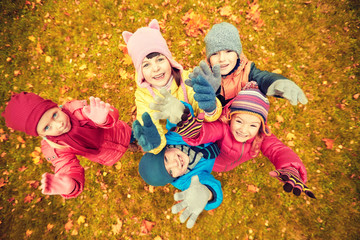 Fototapeta premium happy children waving hands in autumn park