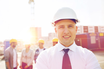 group of smiling builders in hardhats outdoors