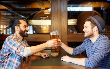 happy male friends drinking beer at bar or pub