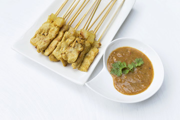 Grill pork satay with thai style peanut sauce on white background