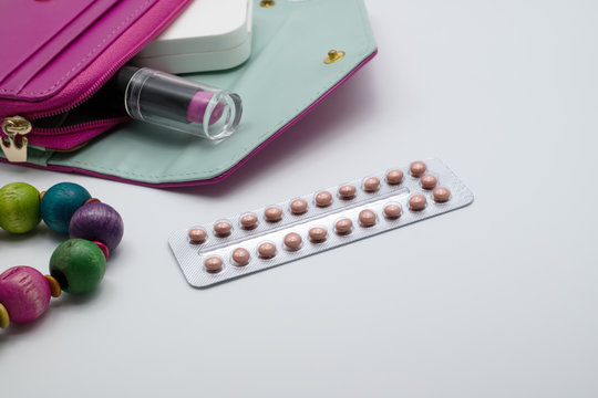 Blisters Of Birth Control  Pills With Pink Purse.