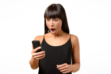 Horrified young woman looking at her mobile