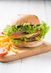 Delicious hamburger on wood palte and wood background