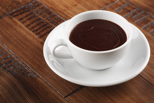 white cup of sweet chocolate on brown wood table