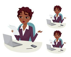 Businesswoman with laptop reading a document at her office