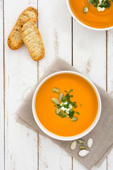 Pumpkin soup on a white wooden table

