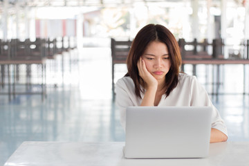 Woman using laptop computer with blurry background