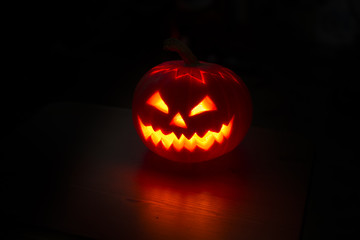 Illuminated halloween pumpkin on black background