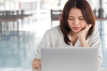 Woman using laptop computer with blurry background