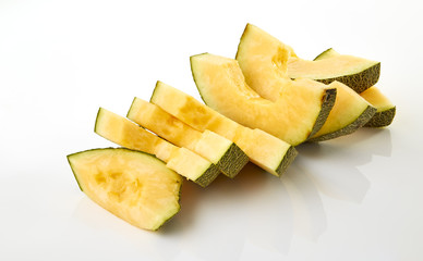 Hamigua Melon cut into slices, Hami Melon, Hami Cantaloupe isolated on white background. stack imag