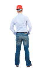 Backview of an engineer in construction helmet stands. Standing young guy. Rear view people collection.  backside view of person.  Isolated over white background. businessman in a white shirt and a