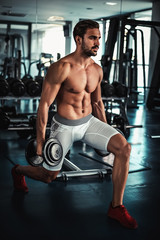 Fototapeta na wymiar Man training legs in the gym