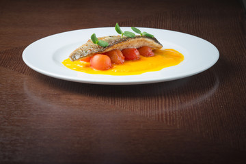 Grilled fish on tomatoes
