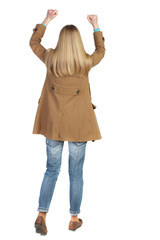 Back view of  woman.  Raised his fist up in victory sign.    Raised his fist up in victory sign.  Rear view people collection.  backside view of person.  Isolated over white background. The blonde in