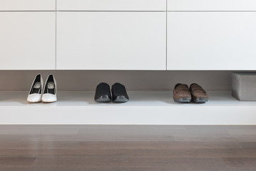 white wardrobe with male and female shoes