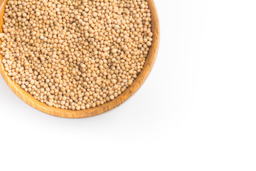 Mustard seeds into a bowl in white background