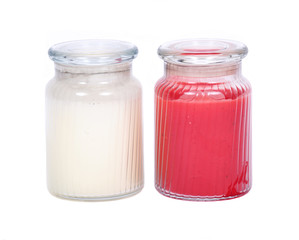 White and red candles in house warmer jar separated on white background