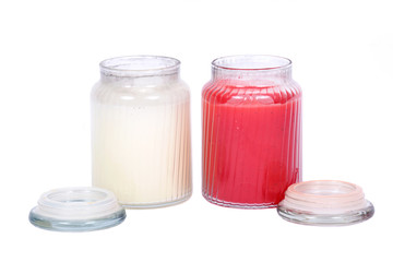 White and red candles in house warmer jar separated on white background
