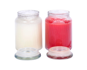 White and red candles in house warmer jar separated on white background