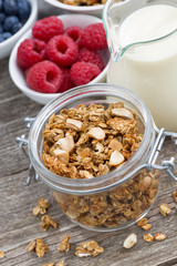 jar with granola, milk, and fresh berries 