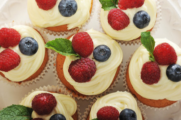 cakes with raspberries and blueberries on a plate