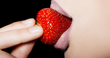 female lips eating red strawberry
